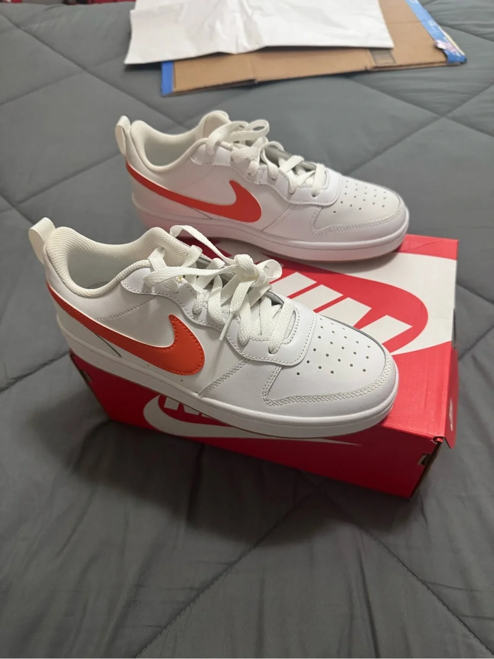 Nike Kids White Sneakers with Orange Swoosh Accent